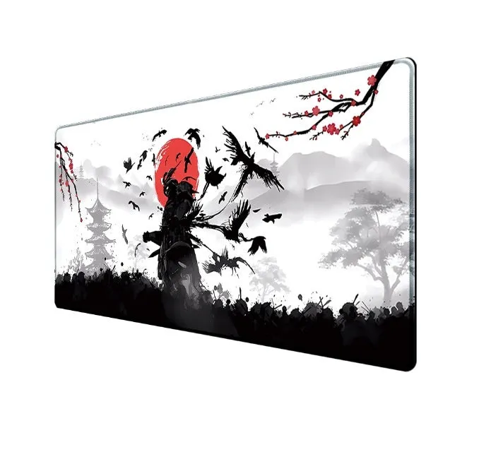 Large black gaming mouse pad with Japanese samurai warrior print and non-slip rubber base on a wooden desk.