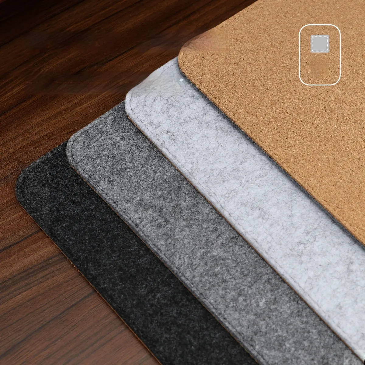 Oversized grey felt and cork office mouse mat on a wooden desk