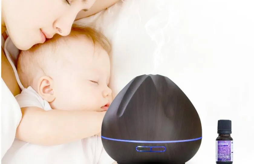 Air humidifier aromatherapy machine with 500ml capacity in dark wood finish on a table