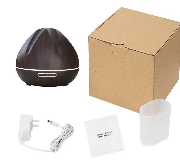 Air humidifier aromatherapy machine with 500ml capacity in dark wood finish on a table