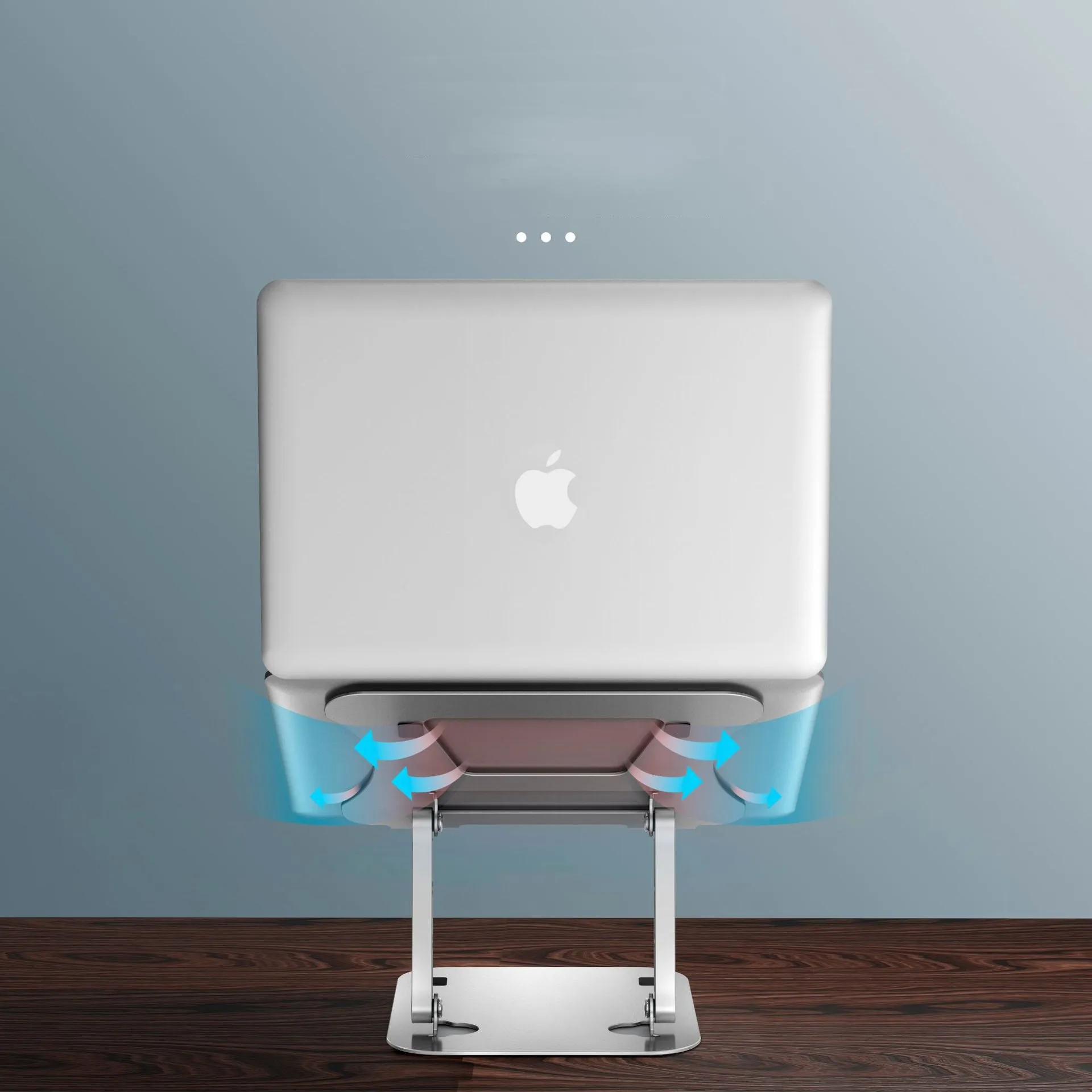 Silver aluminium alloy folding laptop cooling stand on a desk with a notebook placed on it