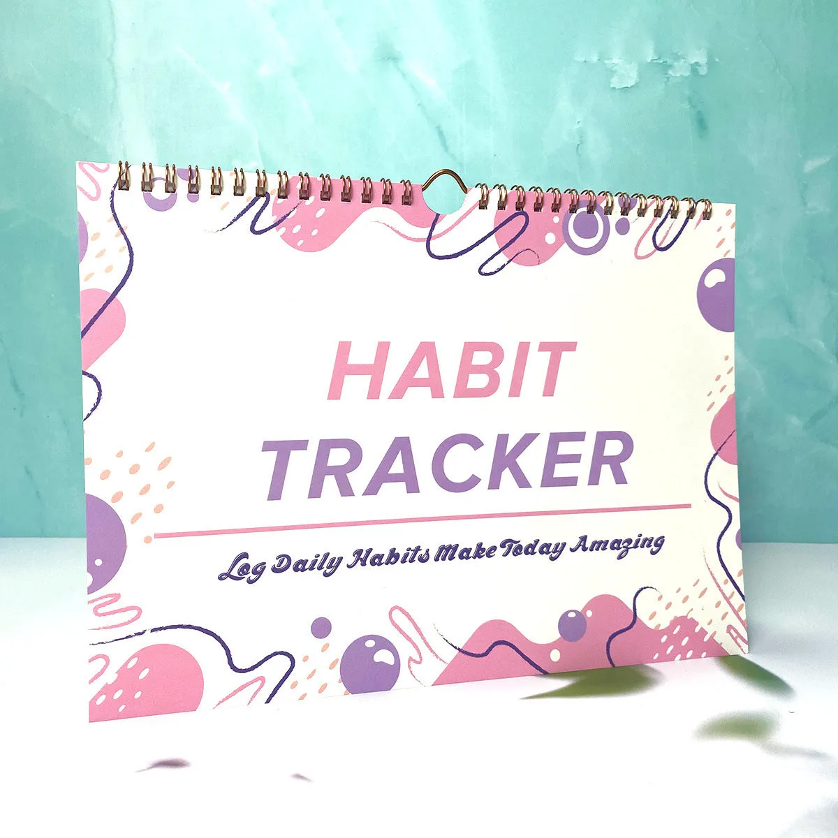 English habit tracking notebook open showing 12 internal pages with A4 21x28cm dimensions