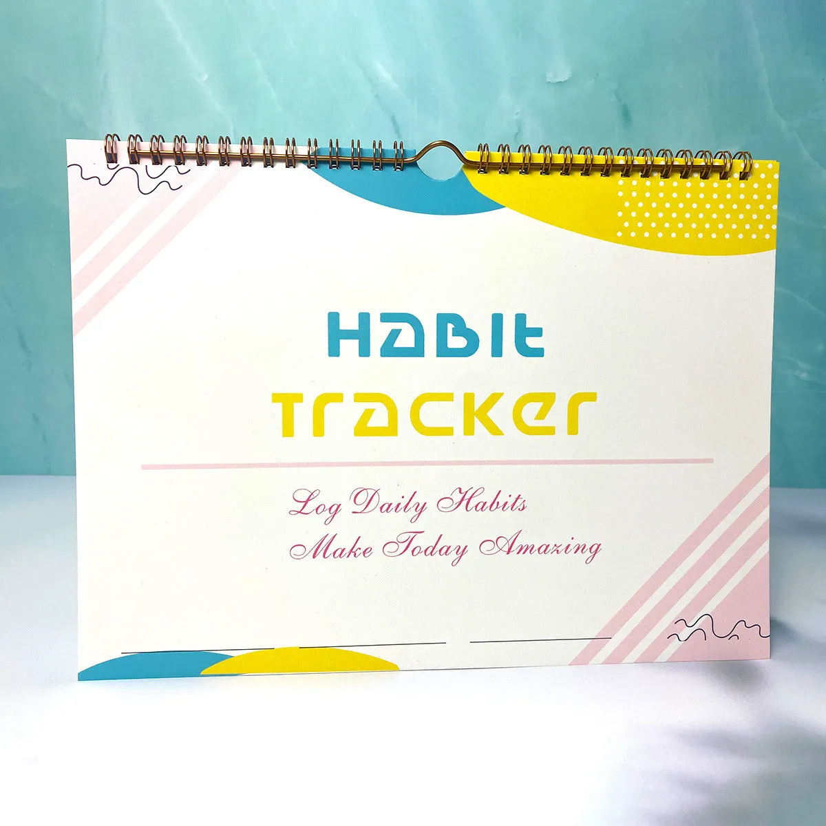 English habit tracking notebook open showing 12 internal pages with A4 21x28cm dimensions