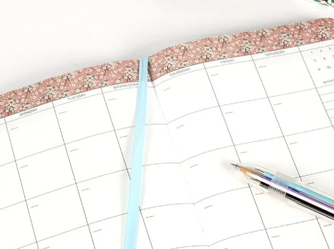 Leather wireless bound notebook with 120gsm Daolin paper in A5 size shown open on a desk with colour cover options