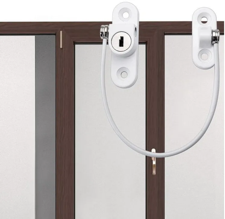 White window security chain lock with steel cable and adhesive base on a window frame