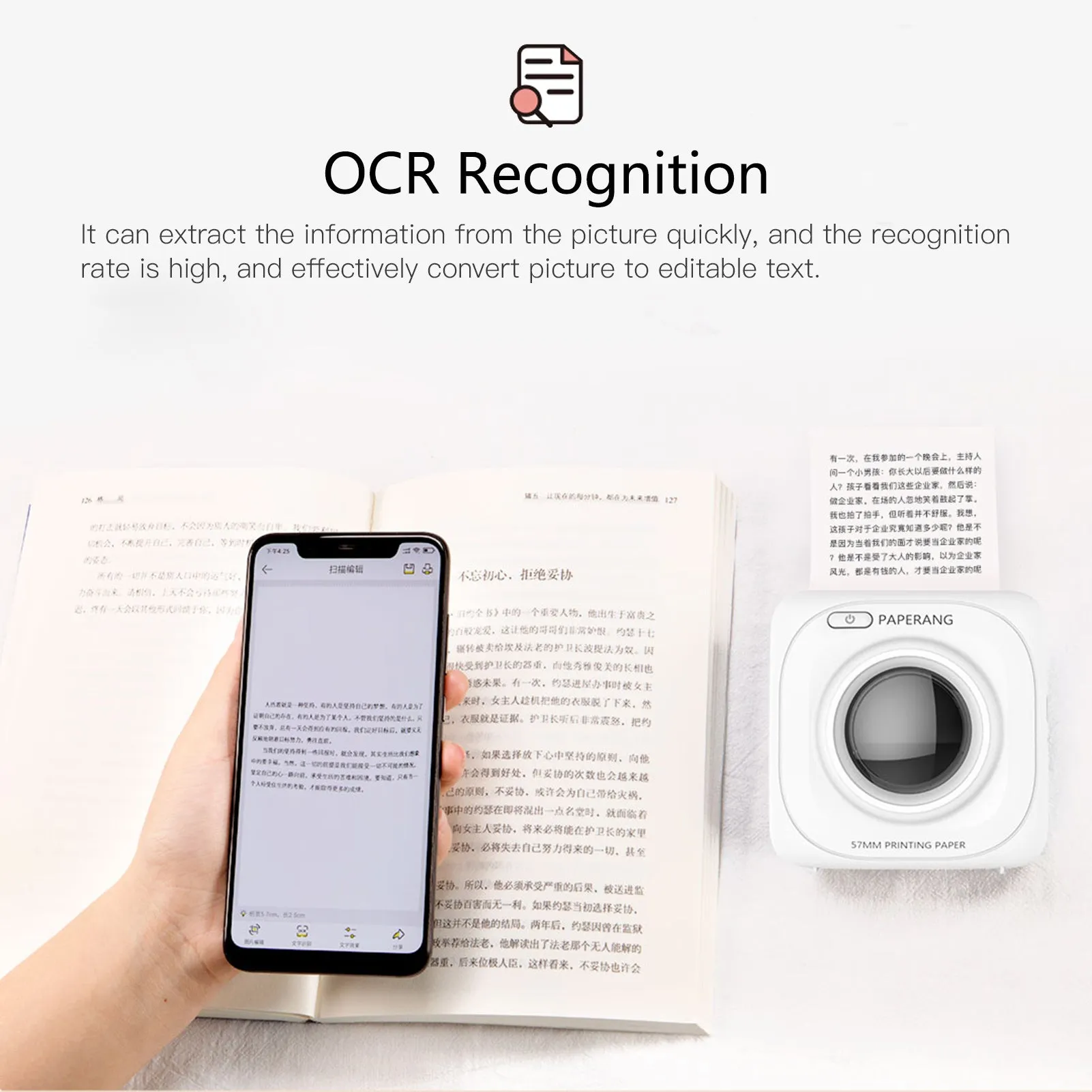 White pocket Bluetooth thermal label printer on desk with smartphone app interface visible