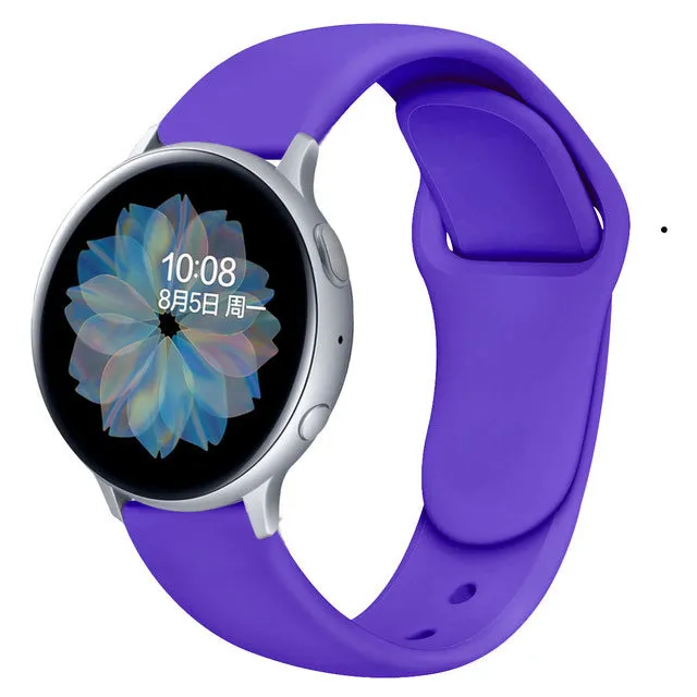 Samsung Galaxy Active 2 smartwatch with a purple silicone replacement strap featuring a reverse buckle clasp.