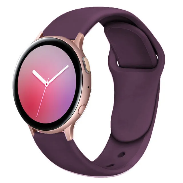 Samsung Galaxy Active 2 smartwatch with a purple silicone replacement strap featuring a reverse buckle clasp.