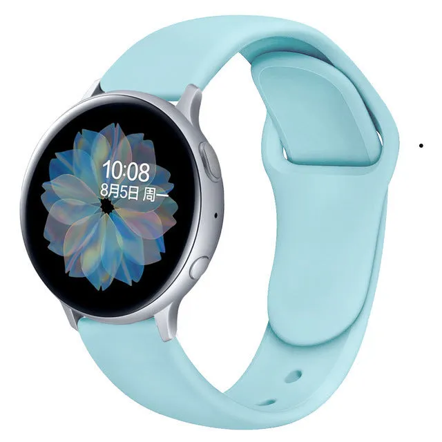 Samsung Galaxy Active 2 smartwatch with a purple silicone replacement strap featuring a reverse buckle clasp.