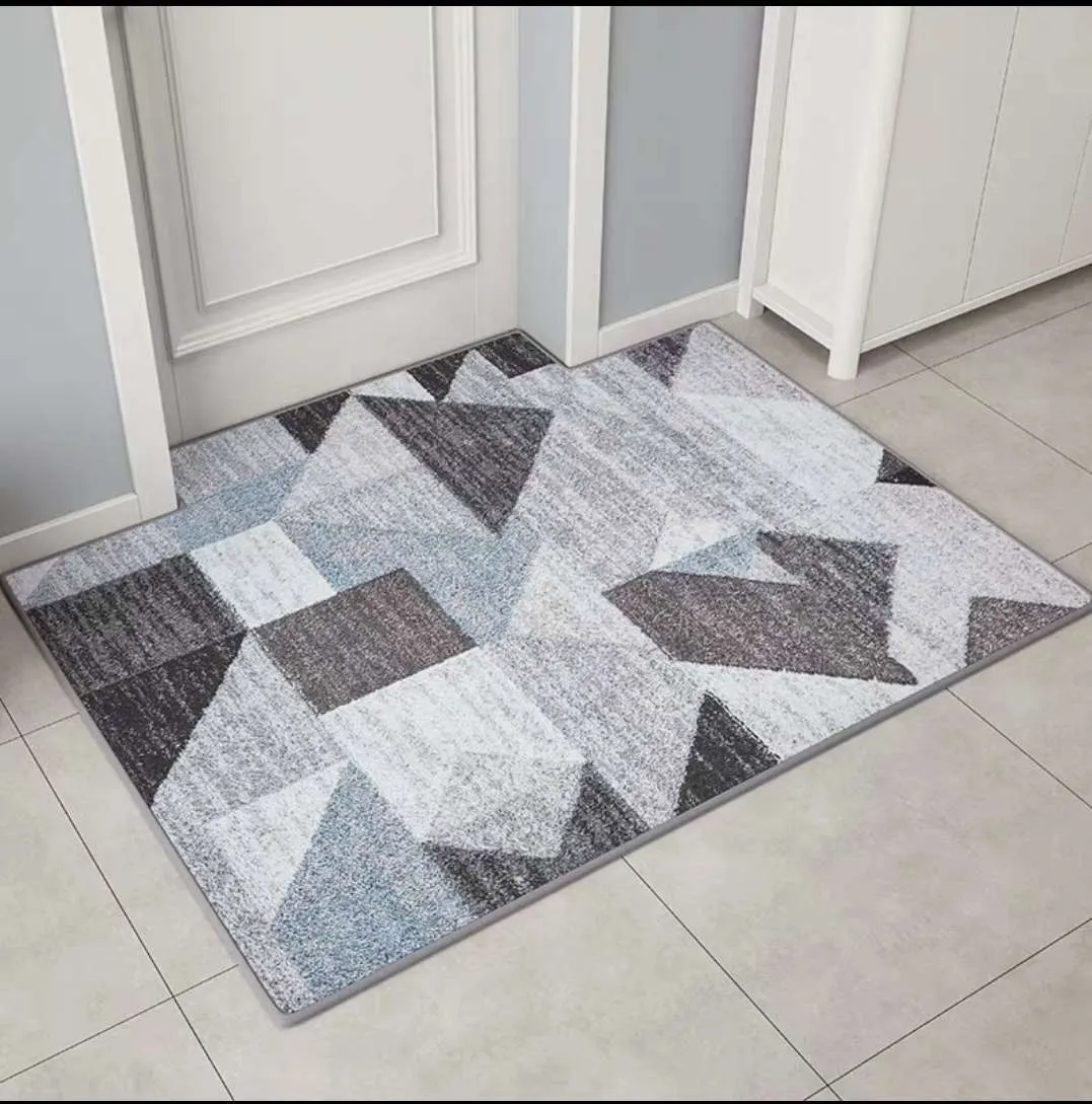 Modern minimalist rectangular floor mat in wave pattern on a tiled entrance floor