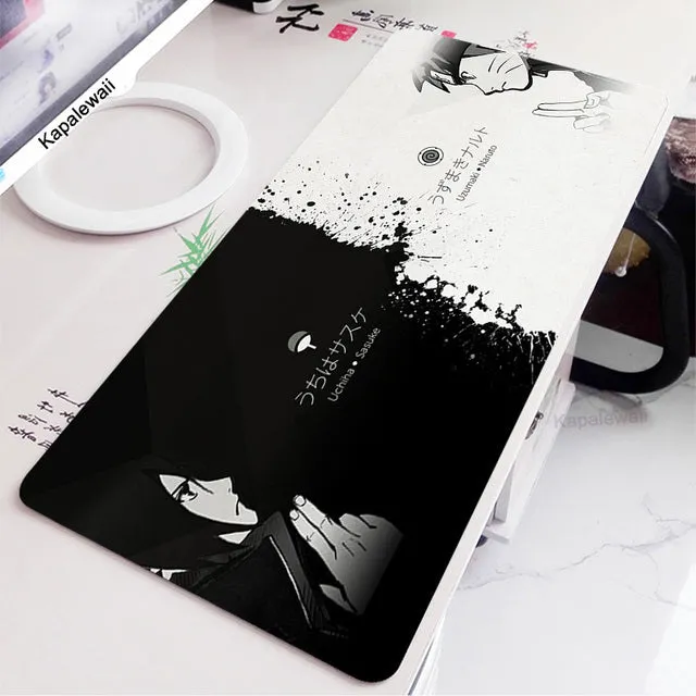 Large black and white gaming mouse pad with non-slip rubber bottom and cloth cover on a desk
