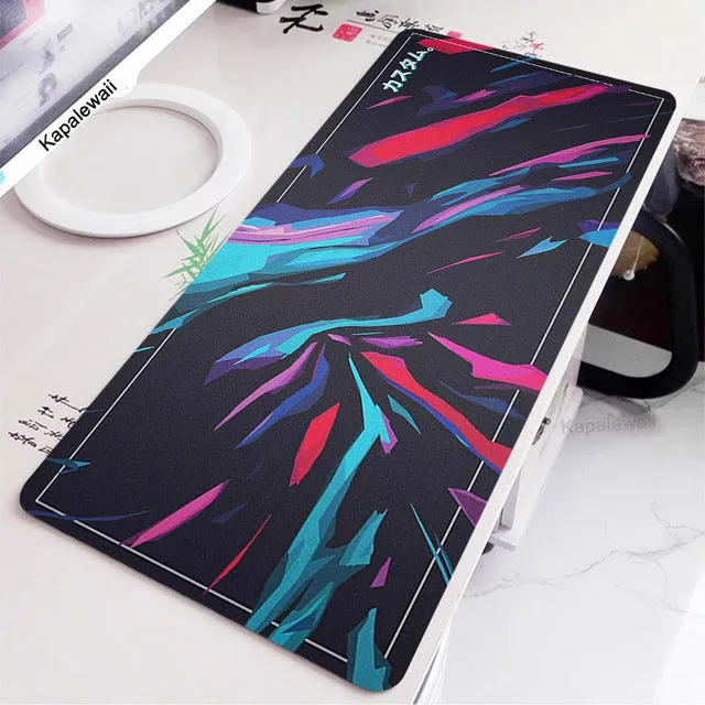 Large black and white gaming mouse pad with non-slip rubber bottom and cloth cover on a desk