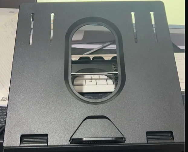 Folding laptop stand in black with 9 adjustable angles, hollow panel, and cooling knob