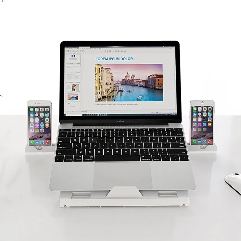Black folding aluminium laptop stand with 9-level angle adjustment and cooling slot, on a desk with a laptop