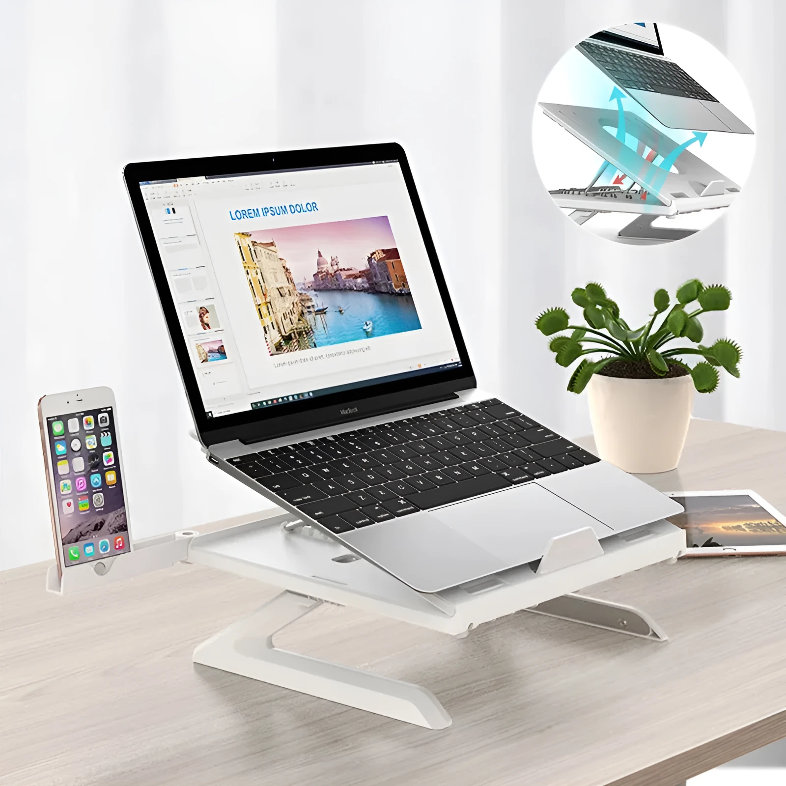 Black folding aluminium laptop stand with 9-level angle adjustment and cooling slot, on a desk with a laptop