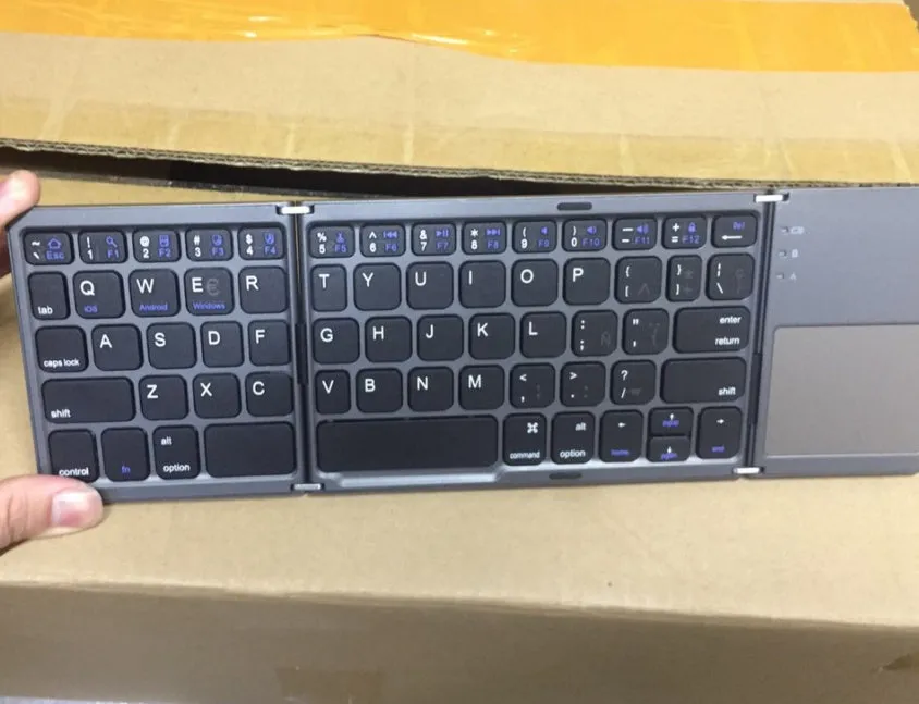 Ultra-thin tri-fold folding touch Bluetooth keyboard in black with touchpad, folded and spread views