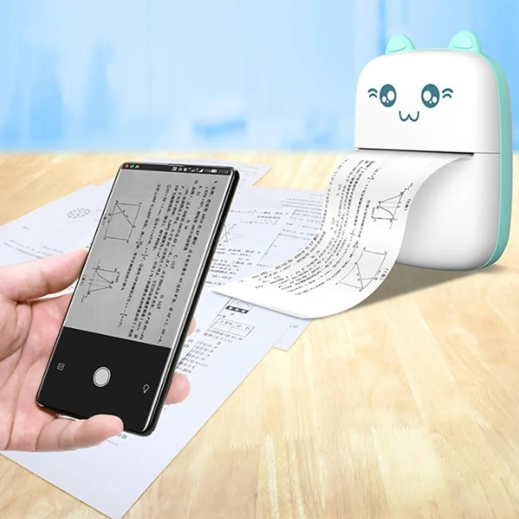 Pink mini Bluetooth thermal printer on a desk with a phone and printed note, measuring 11x8x3.5cm