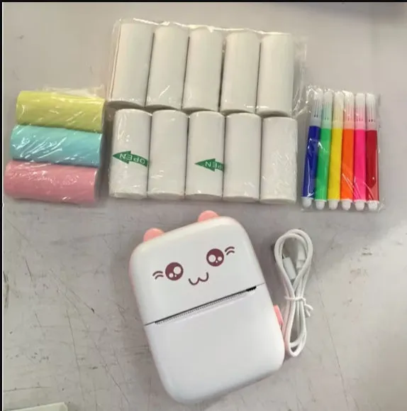 Pink mini Bluetooth thermal printer on a desk with a phone and printed note, measuring 11x8x3.5cm