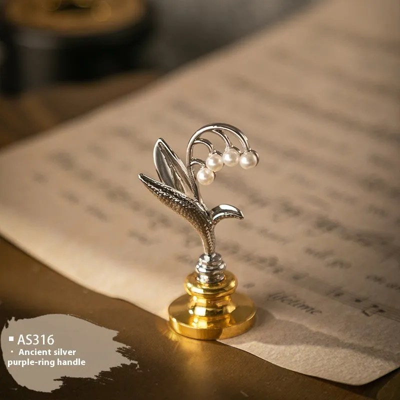 Wooden wax seal handle tool showing various style options like lily, owl platform, and Roman column designs.