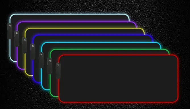 RGB luminous mouse pad with multi-colour LED lighting, fabric surface, and rubber base, shown on a desk with a mouse and keyboard