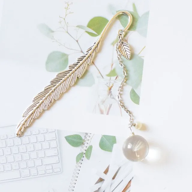 Creative metal bookmark with a dried flower inside, showing colour options like blue starry sky and dandelion.