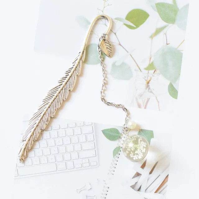 Creative metal bookmark with a dried flower inside, showing colour options like blue starry sky and dandelion.