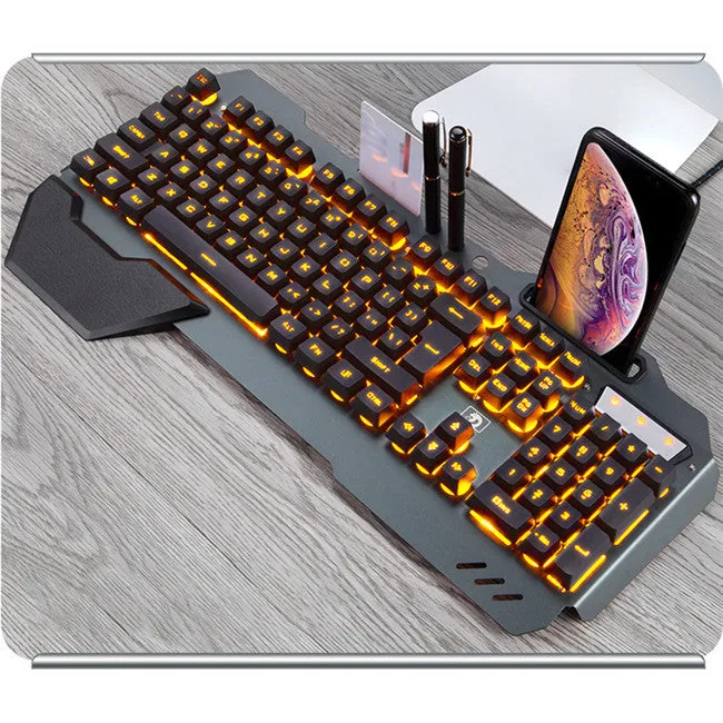 Black wired gaming keyboard with RGB backlight, floating keycaps, phone holder slot, pen slot, and card slot on a desk