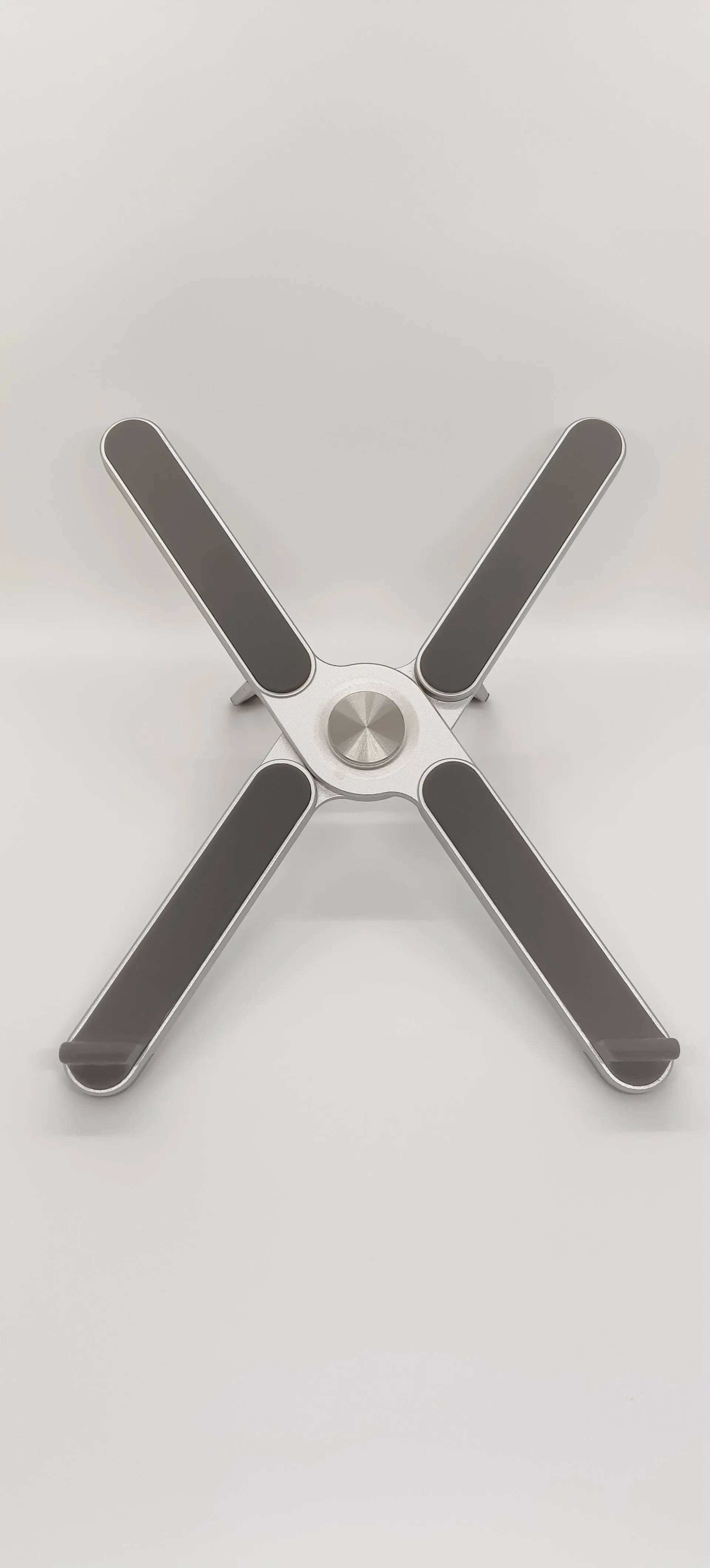 Foldable aluminium alloy laptop bracket in silver on a desk with notebook computer