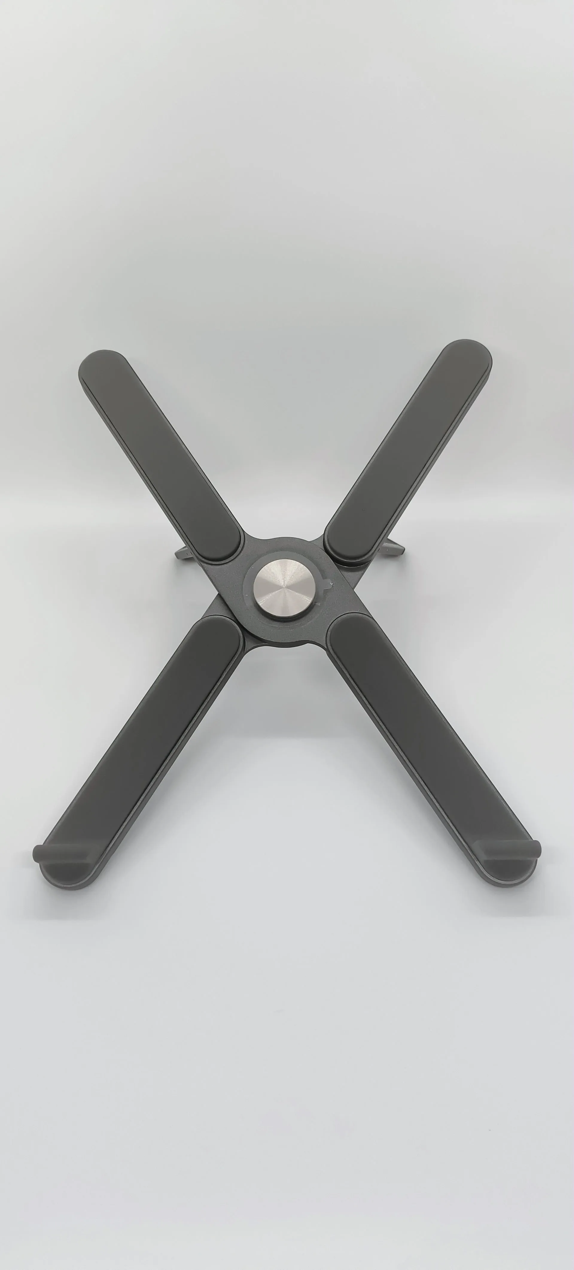 Foldable aluminium alloy laptop bracket in silver on a desk with notebook computer