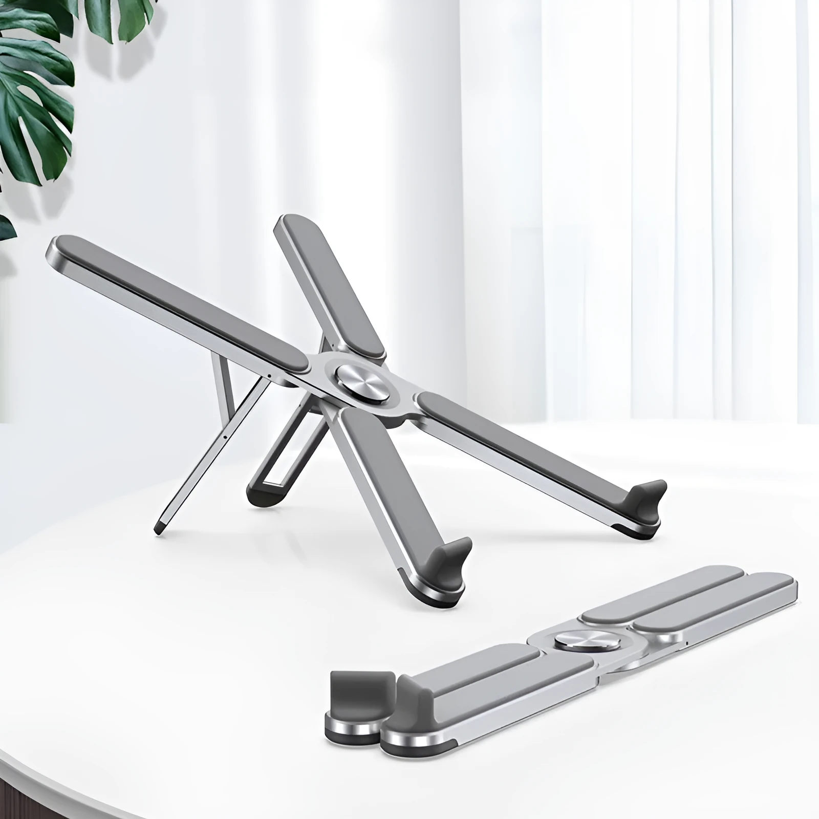 Foldable aluminium alloy laptop bracket in silver on a desk with notebook computer