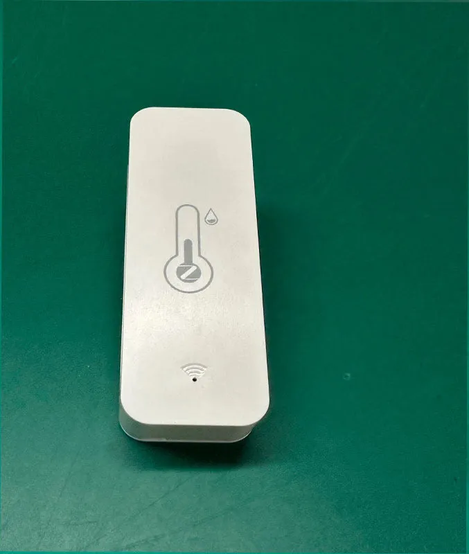Compact white WiFi temperature and humidity sensor with LCD display for smart home monitoring
