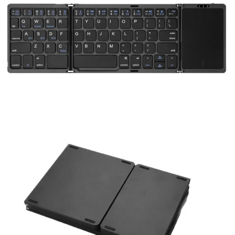 Three folding wireless Bluetooth keyboard with touch pad in black, open on a table next to a mobile phone