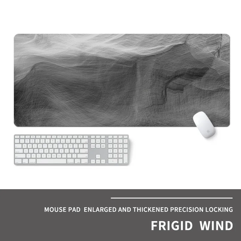 Oversized natural rubber mouse pad with printed graphic and integrated wrist support on a desk.