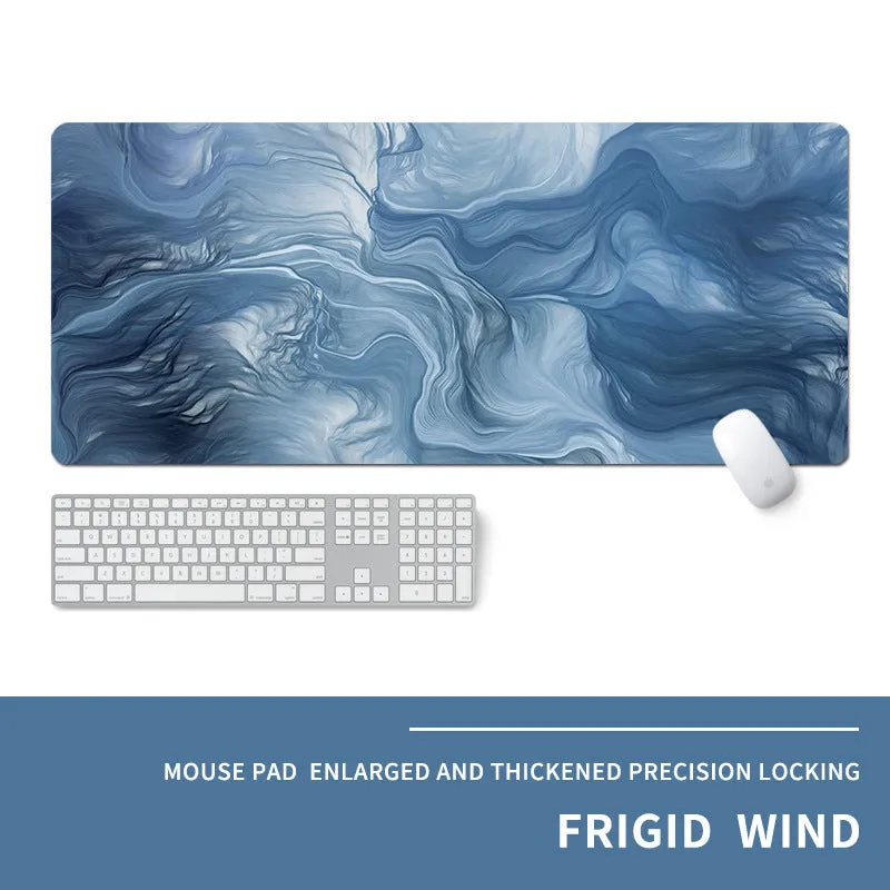 Oversized natural rubber mouse pad with printed graphic and integrated wrist support on a desk.