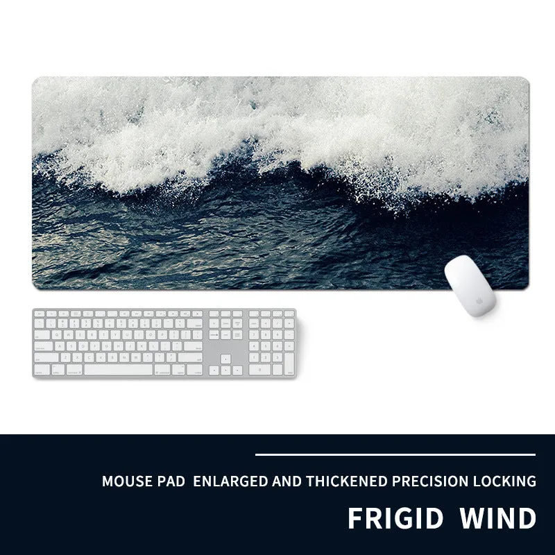 Oversized natural rubber mouse pad with printed graphic and integrated wrist support on a desk.