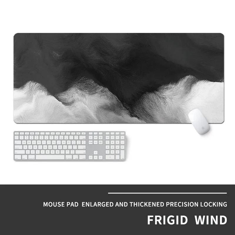 Oversized natural rubber mouse pad with printed graphic and integrated wrist support on a desk.