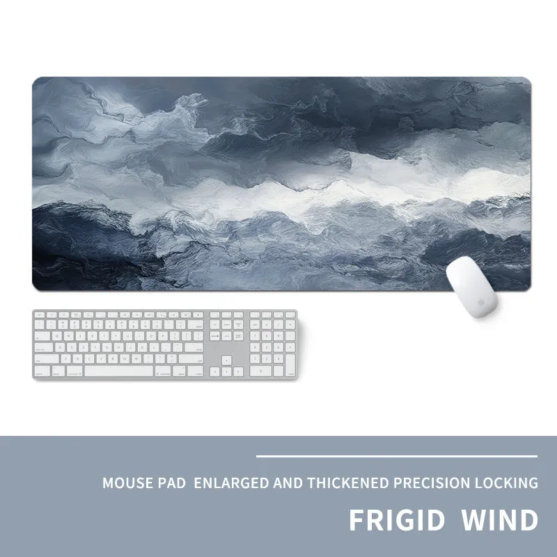 Oversized natural rubber mouse pad with printed graphic and integrated wrist support on a desk.