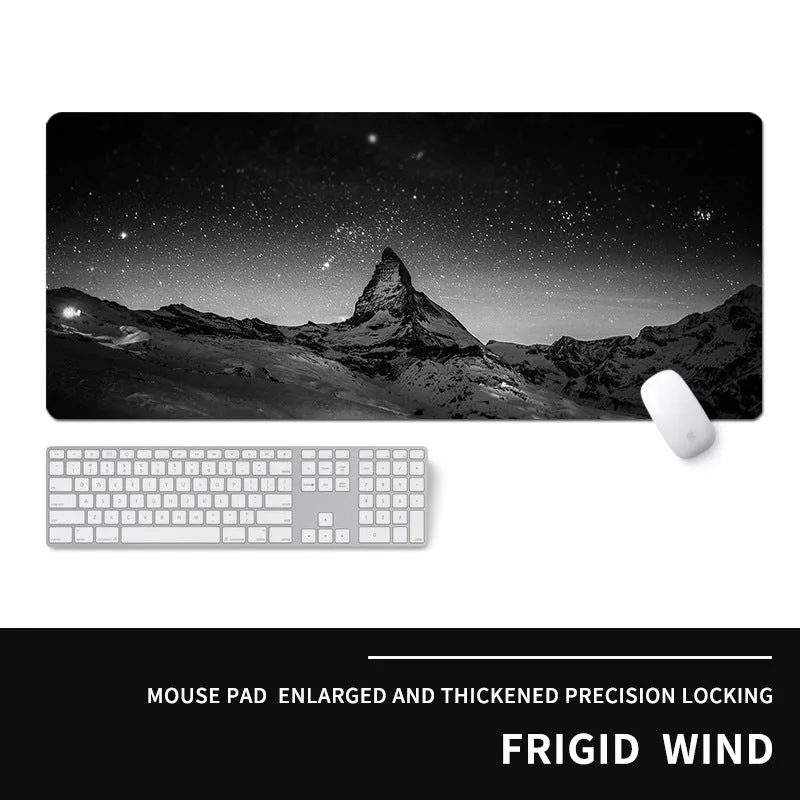 Oversized natural rubber mouse pad with printed graphic and integrated wrist support on a desk.