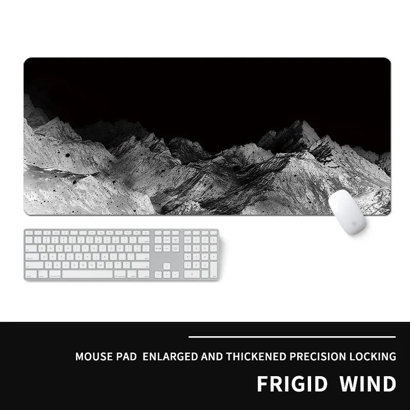 Oversized natural rubber mouse pad with printed graphic and integrated wrist support on a desk.