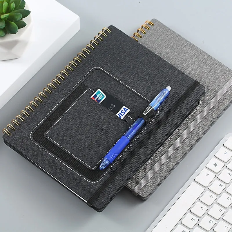 Erasable reusable coil notebook with rock stone paper, shown with a pen and cleaning cloth on a customisable cover.