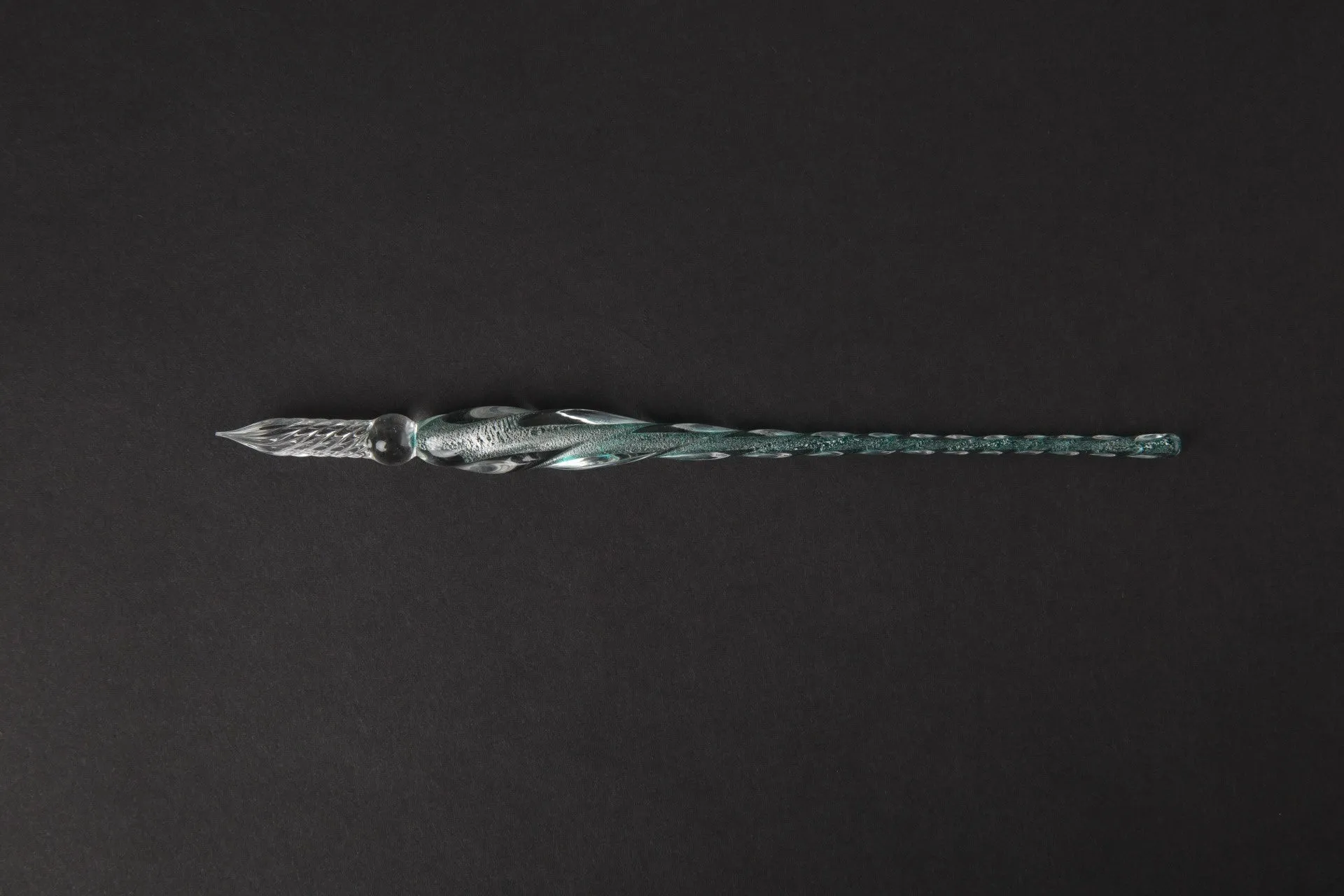 Transparent glass crystal pen with coloured ink visible inside, 0.5mm fine tip, simple modern design