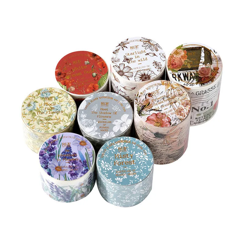 Roll of vintage floral watercolour washi tape on a Japanese paper base, showing patterns like Fog Mountain Forest.