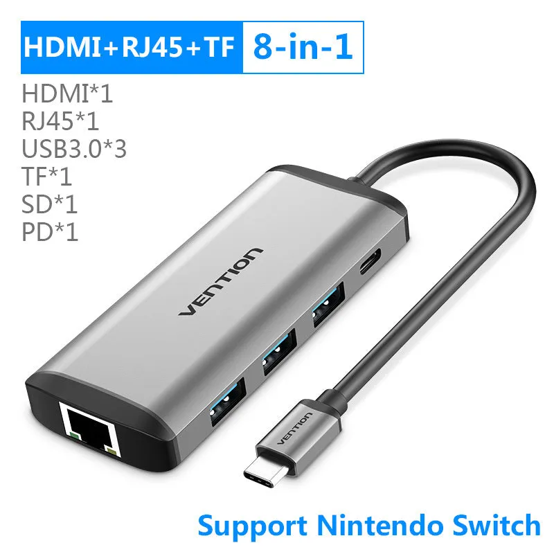 Deep grey Type-C to HDMI USB3.0 Ethernet adapter hub with SD and TF card slots on a desk.