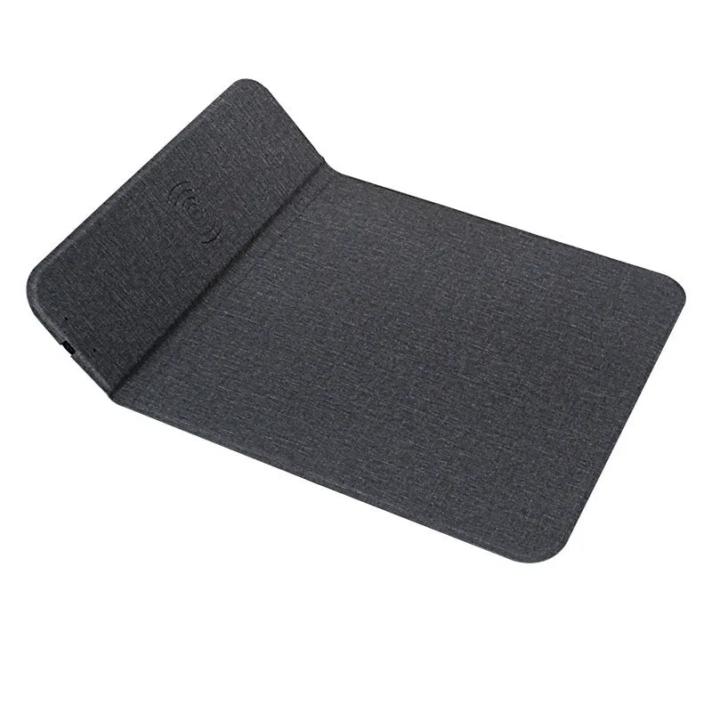 Grey foldable cloth phone holder with wireless charging stand on a desk