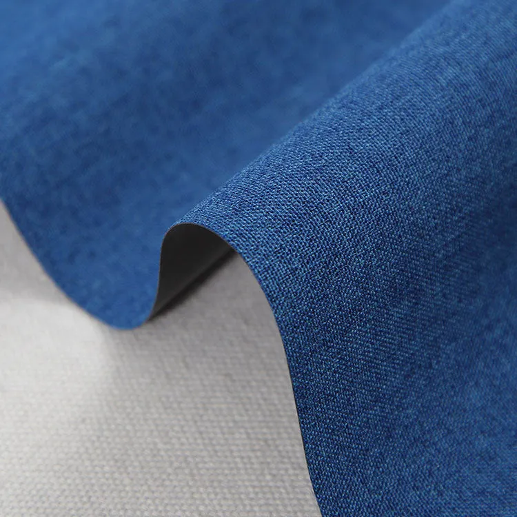 Roll of black polyester fabric with a white snowflake and dragon pattern, sold by the metre for covering projects.