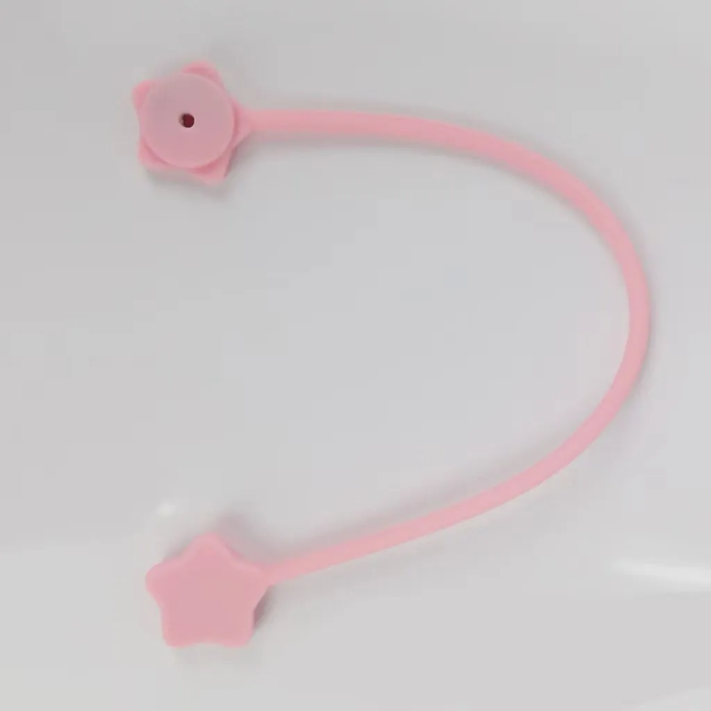 Purple silicone wire winder with magnet for organising headphone and computer cables.
