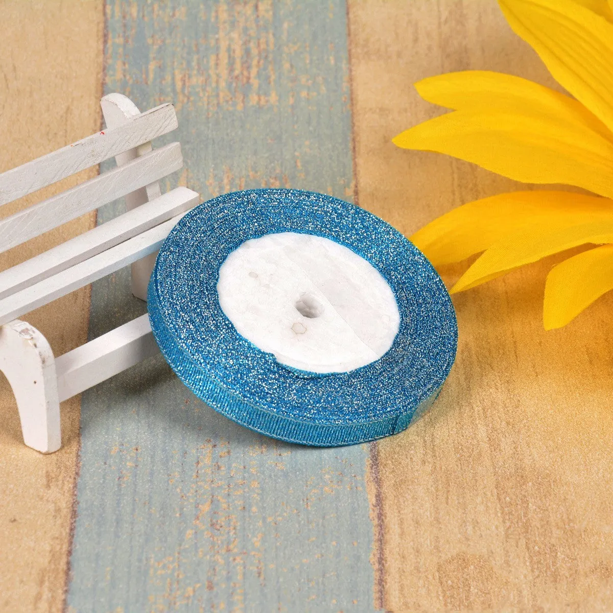 Close-up of green onion patterned polyester ribbon with metallic wire accents on a 25-yard roll.