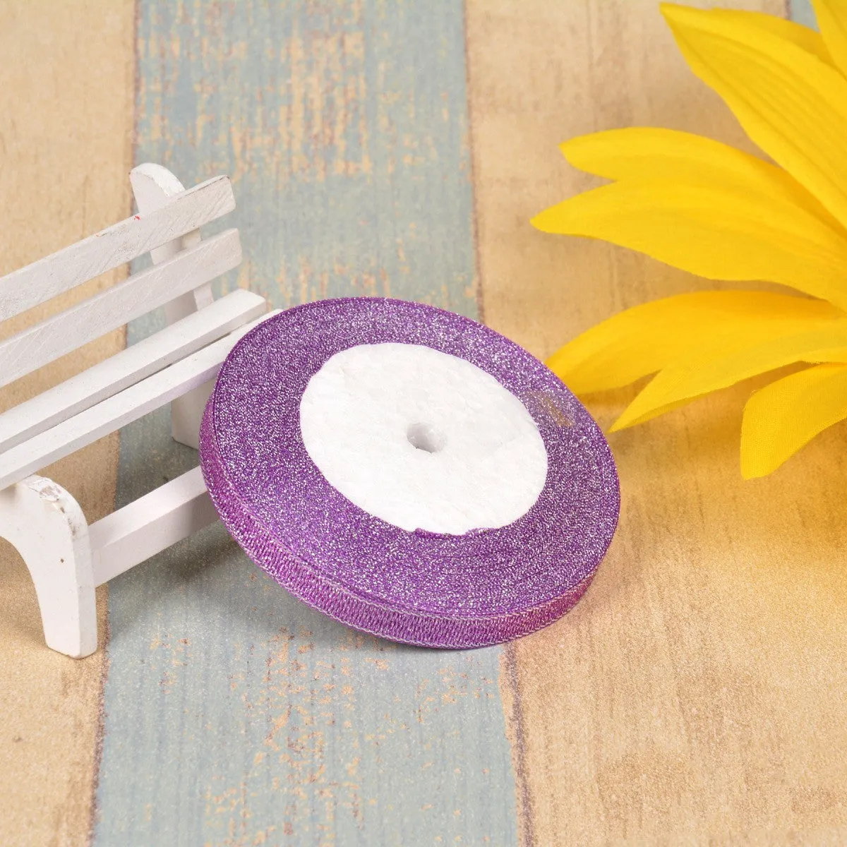 Close-up of green onion patterned polyester ribbon with metallic wire accents on a 25-yard roll.