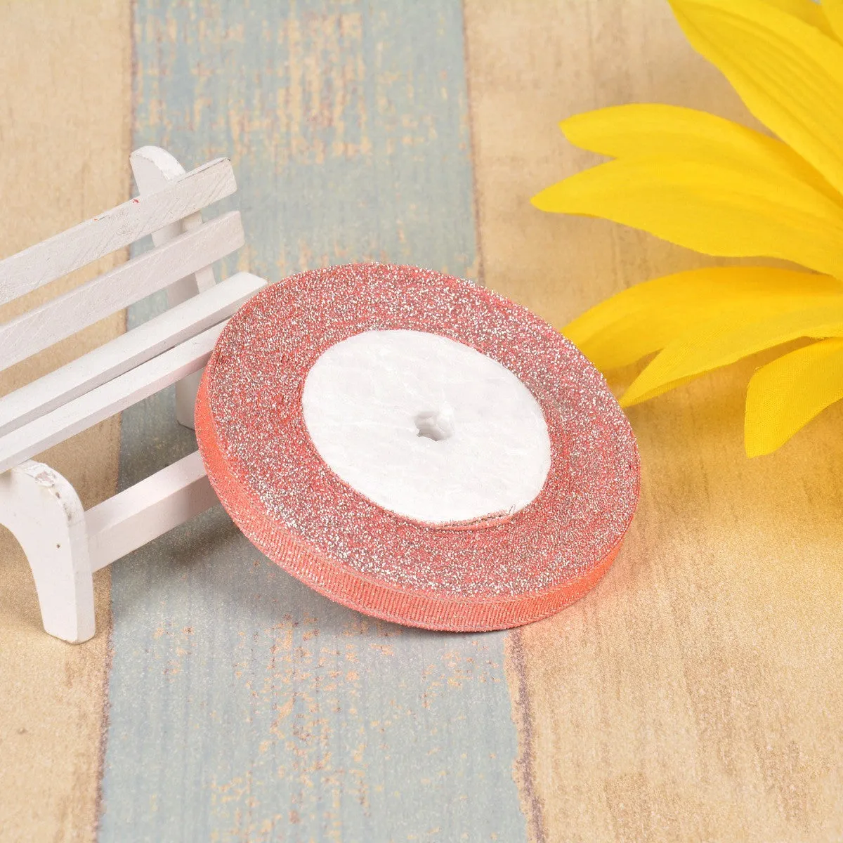 Close-up of green onion patterned polyester ribbon with metallic wire accents on a 25-yard roll.