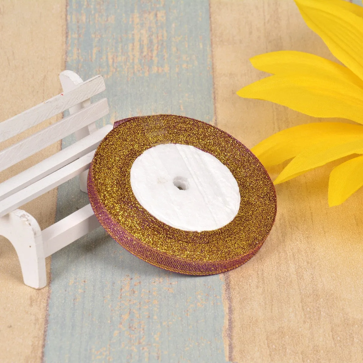 Close-up of green onion patterned polyester ribbon with metallic wire accents on a 25-yard roll.